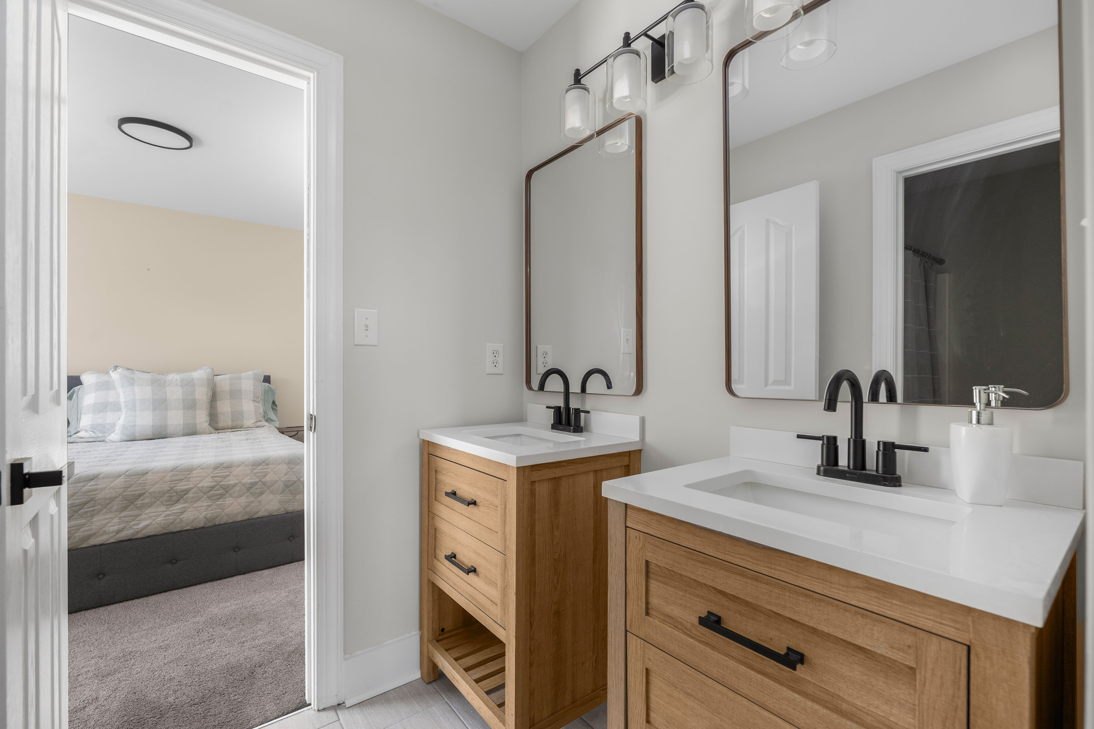 Second-floor bedroom with Jack and Jill bathroom featuring dual vanities and a separate shower and toilet area.