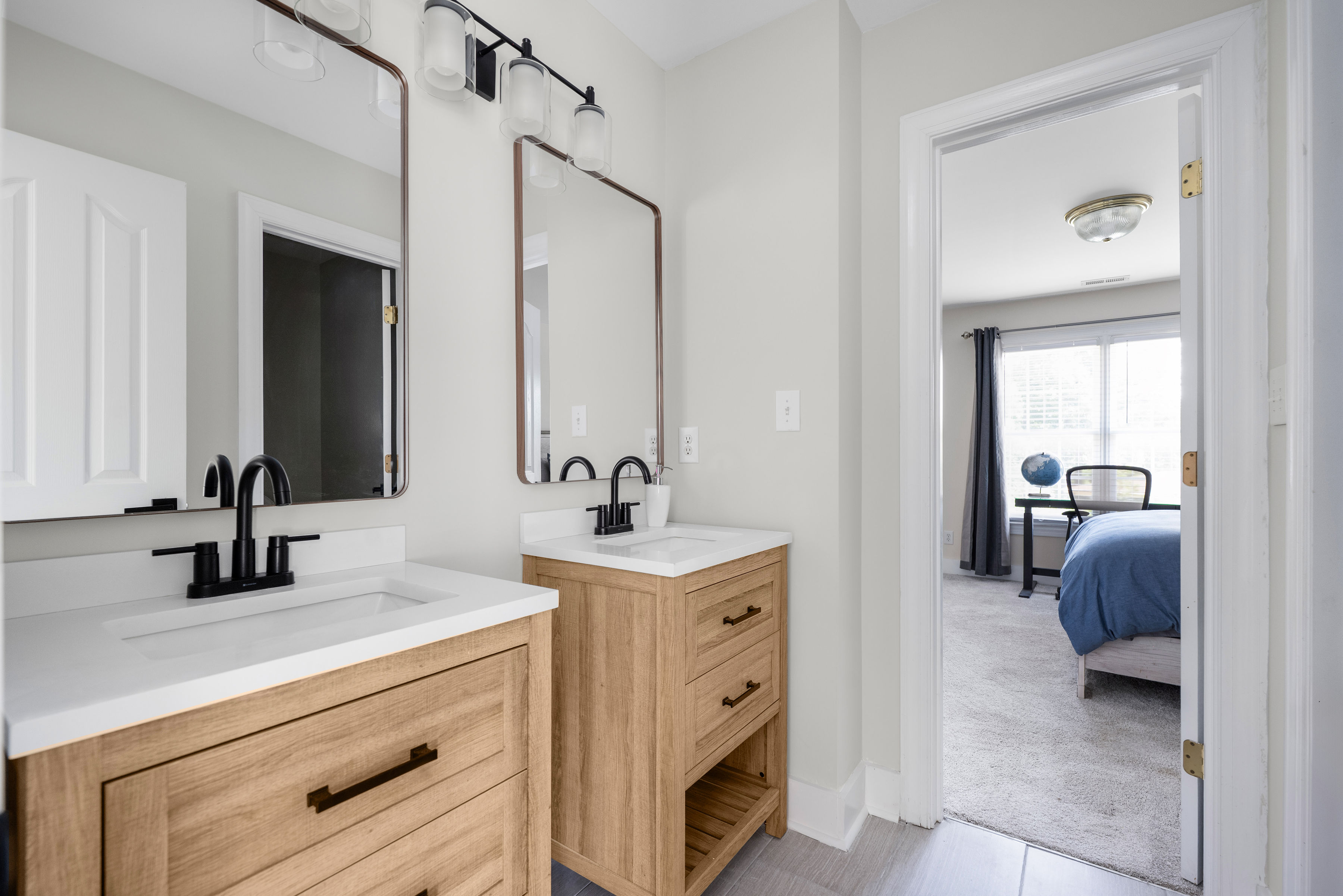 Second-floor bedroom with Jack and Jill bathroom featuring dual vanities and a separate shower and toilet area.