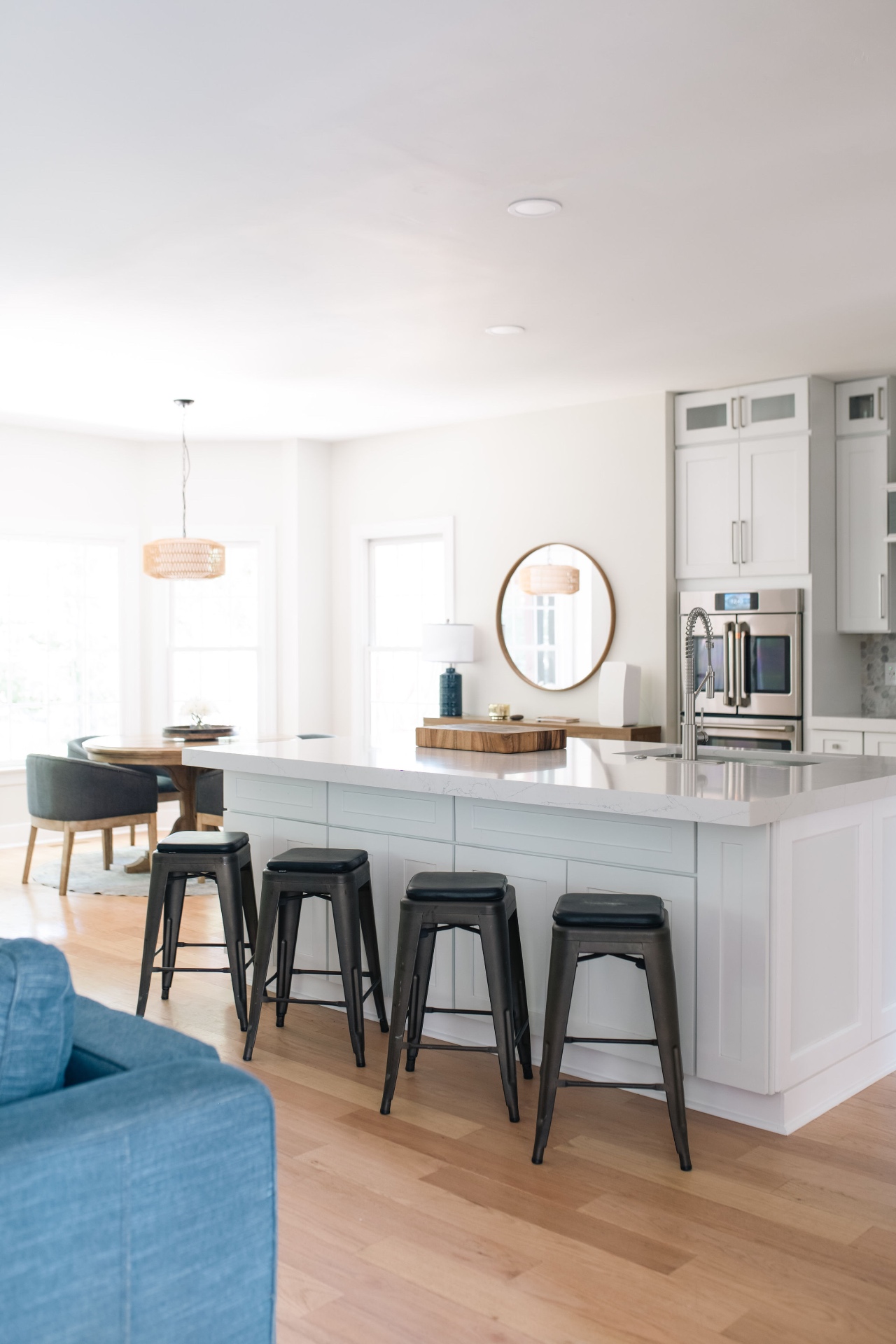 Open kitchen with oversized island seating, pro-style faucet, and adjacent breakfast nook.